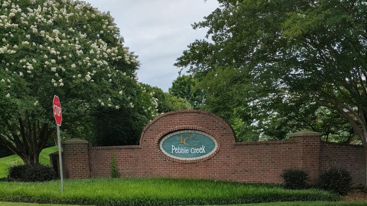 Pebble Creek entrance sign with flowers